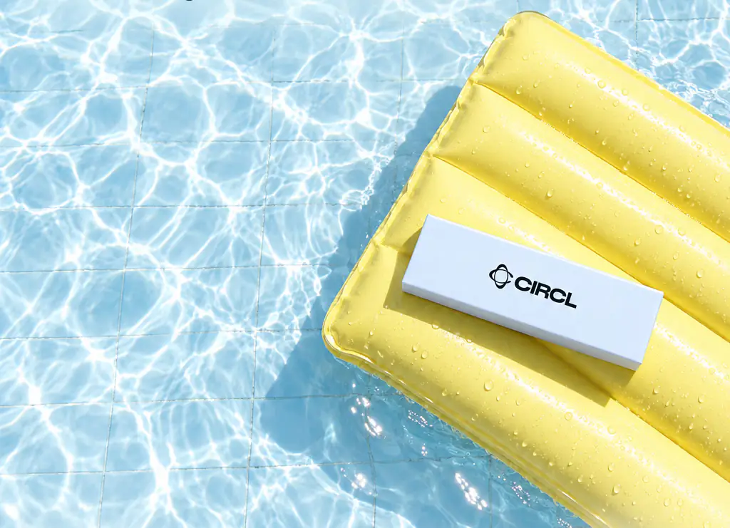 CIRCL treatment box resting on a yellow pool float in clear blue water